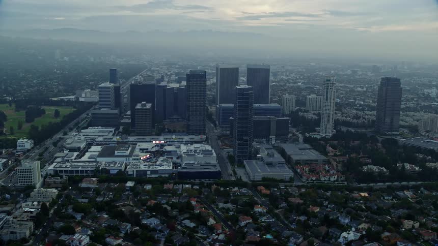 A stunning aerial view of a shopping mall nestled between high-rise office buildings at sunrise in Century City California