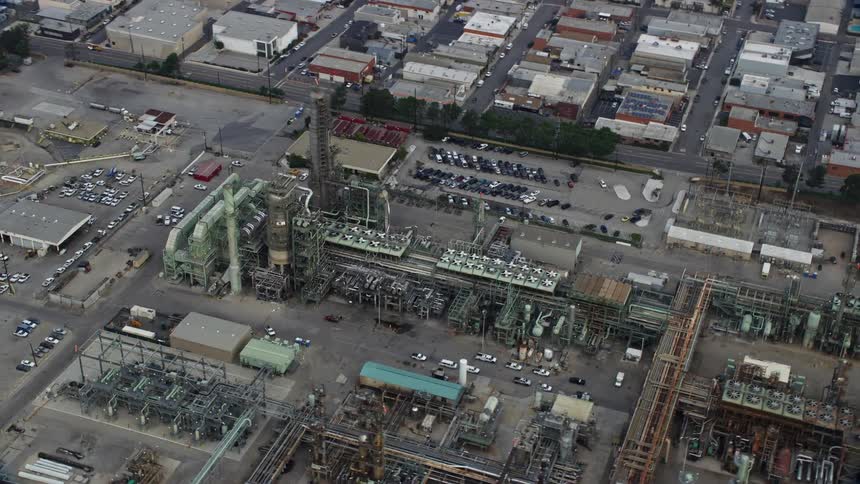Morning aerial view flying over oil refinery structures in El Segundo CA