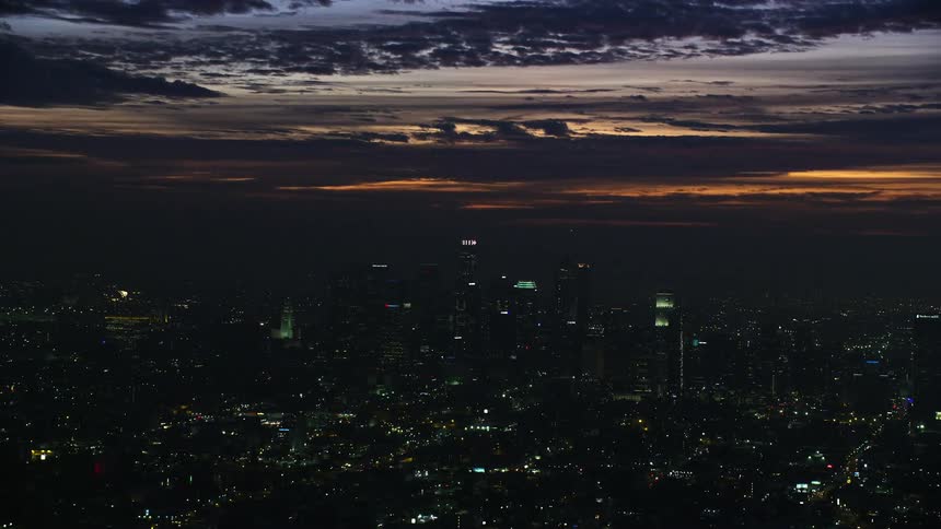 A stunning aerial view at sunrise of the Downtown Los Angeles skyscrapers and cloudy skies during wintertime in Southern California