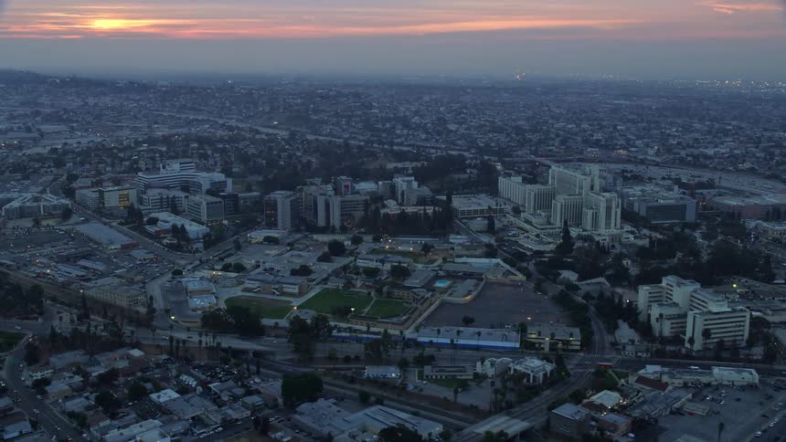 Aerial footage shows USC Health Sciences Campus Boyle Heights at sunrise during winter with cloudy skies and medical centers in view