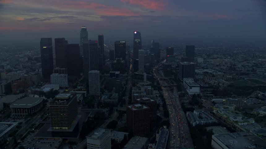 Flying above City Hall and downtown Los Angeles experiencing the early morning haze and admiring the towering skyscrapers of Southern California