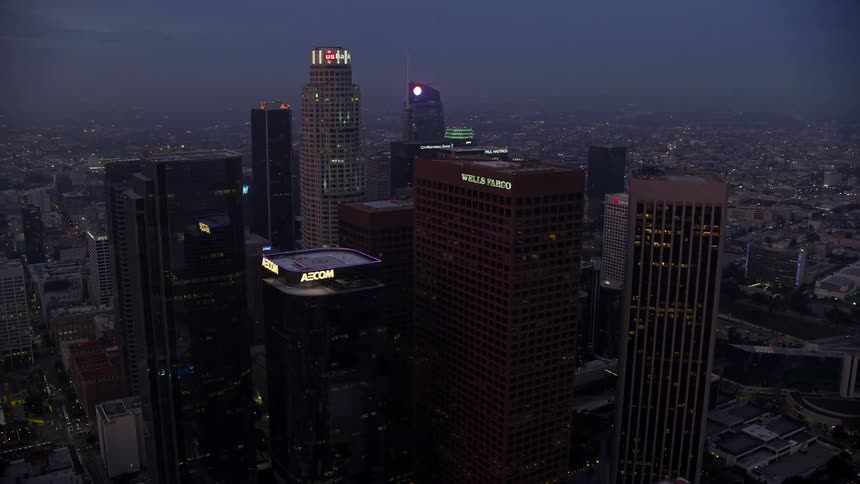 Aerial footage of Downtown Los Angeles skyscrapers towering over the city at sunrise