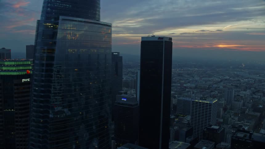 Approaching the hazy Downtown Los Angeles skyline with the Wilshire Grand Center Tower during a winter sunrise