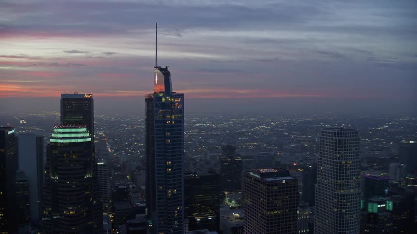 Aerial footage of Downtown Los Angeles skyscrapers and the Wilshire Grand Center at sunrise in California during winter