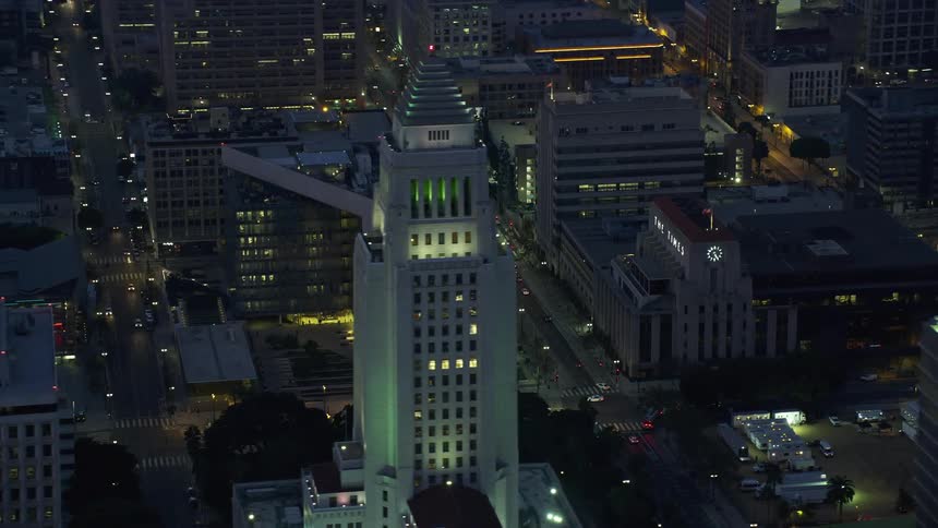 A sunrise aerial view of LAPD Headquarters LA Times Building and City Hall in Downtown Los Angeles during winter revealing a glimpse of the citys government and law enforcement buildings