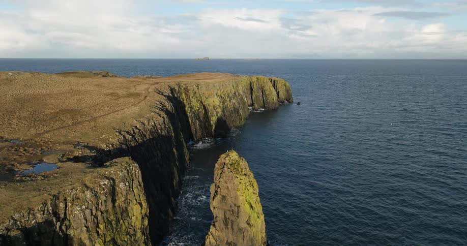 An aerial view of coastal land on a cloudy day