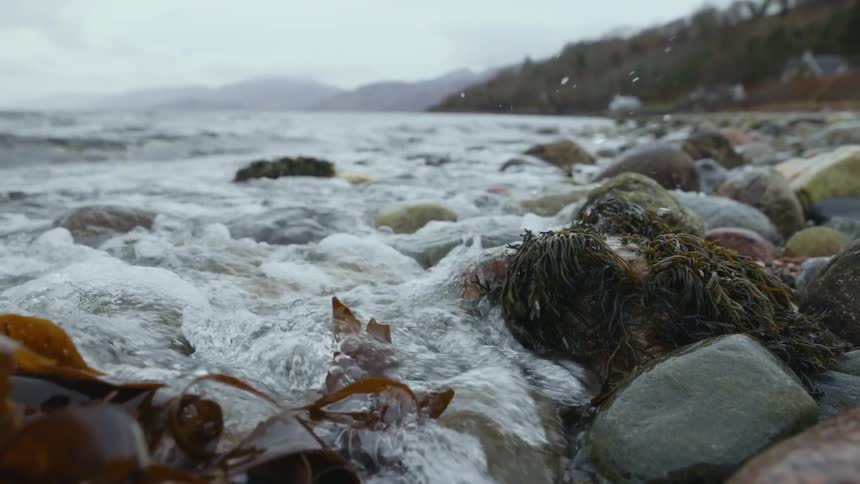 Ocean waves washing ashore a rocky beach