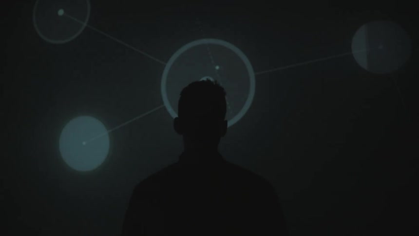 A man watches lights flash on a wall