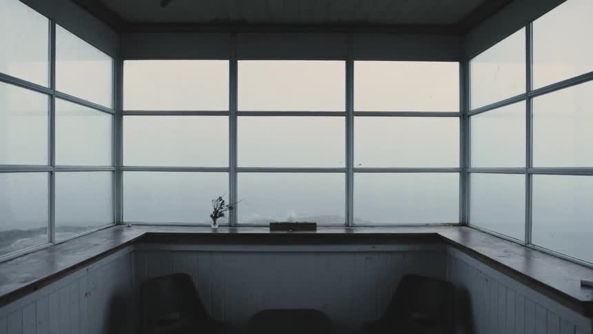 Foggy windows on the balcony obscure the view at evening