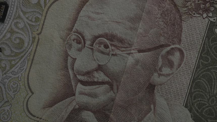Light shines on a piece of paper currency