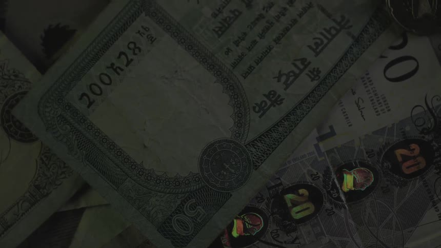 Paper money and notes laid out on a surface