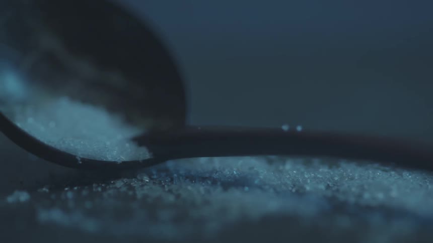 A spoon lays on this table