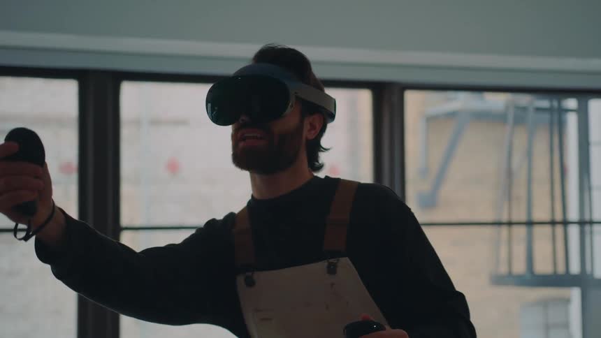 A man is playing a virtual reality game in his house