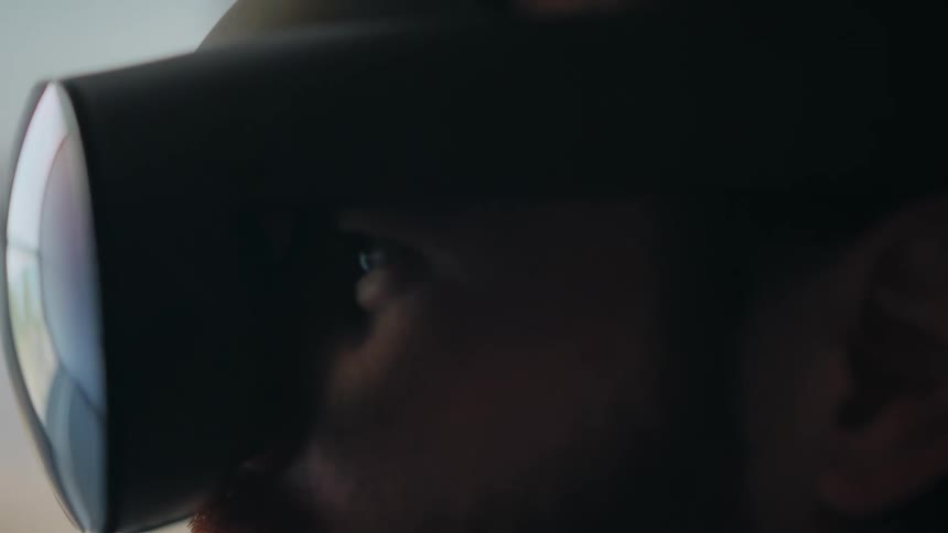 Man blinks while watching images play from vr goggles