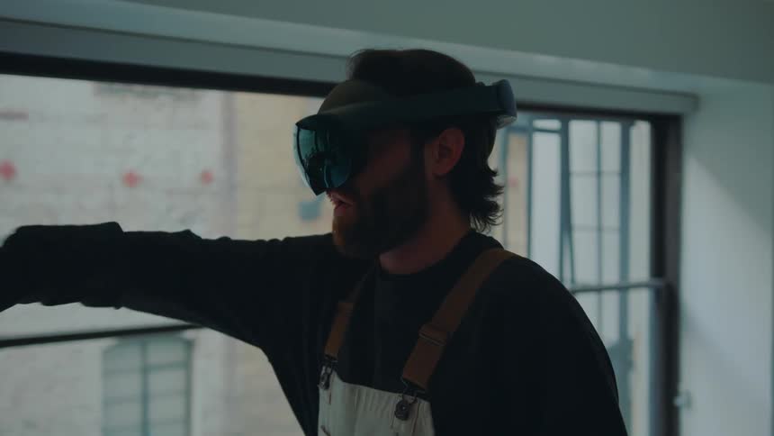 A man jumps up in his apartment while playing a virtual reality game