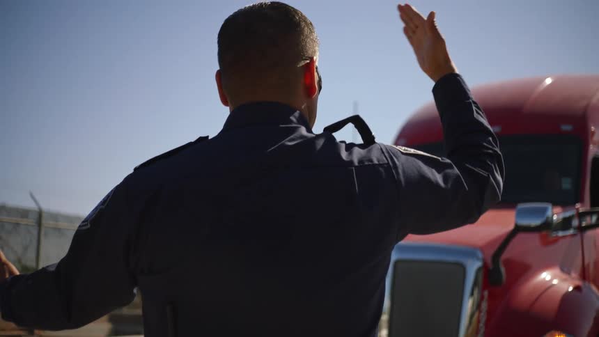 A police officer is pulling over a truck