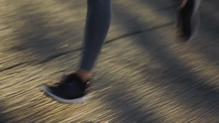 Sun prism effect covers woman jogging along road