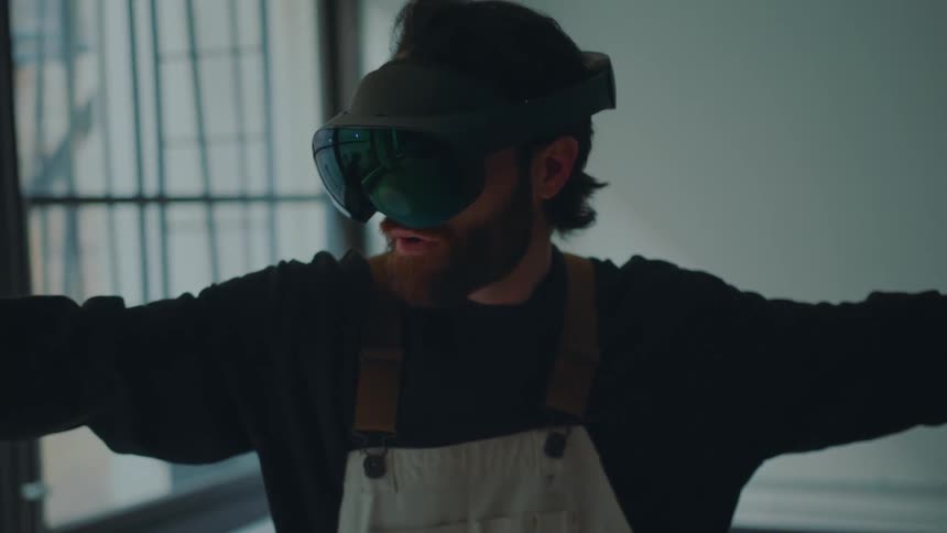 A man raises his arms while playing a virtual reality game