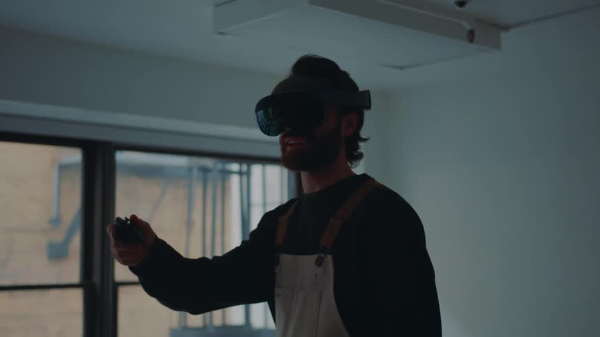 A man walking while wearing a virtual reality headset indoors