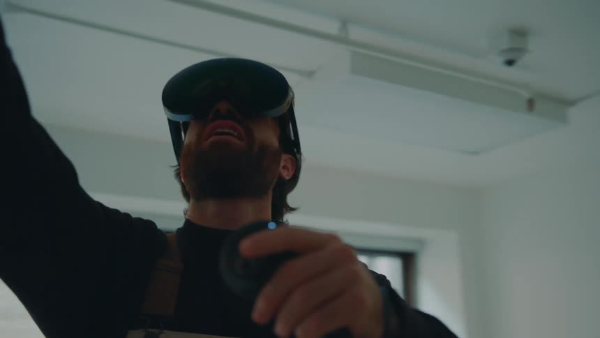 A man reaches around using a virtual reality headset