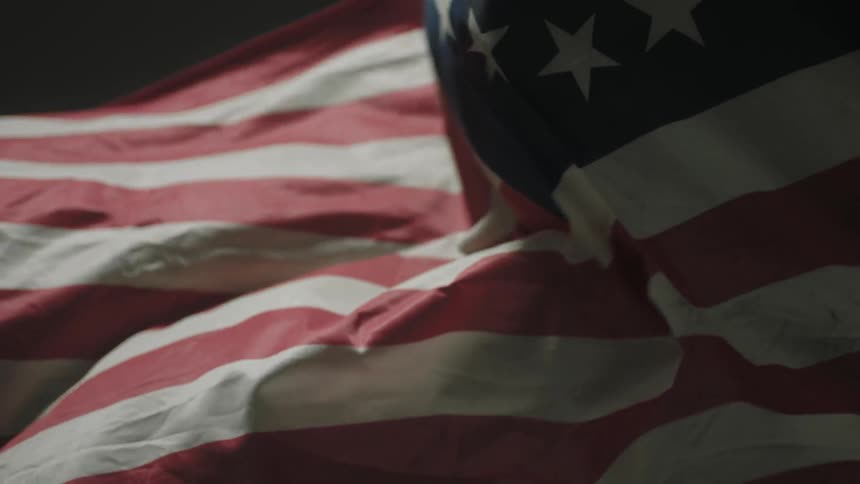 A flag is waved in a room