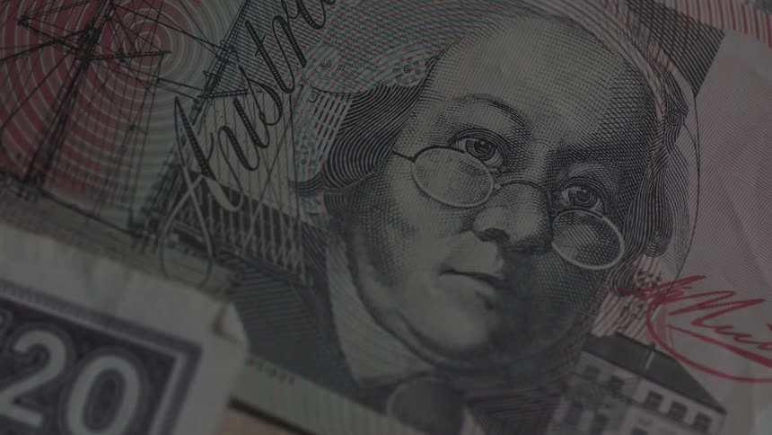 A clear bar passing over two pieces of paper money