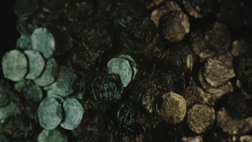 A pile of coins drop on the ground