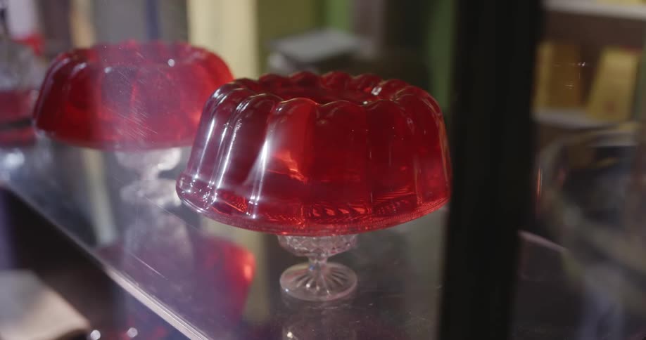 Jiggly red jello molds on glass serving platters