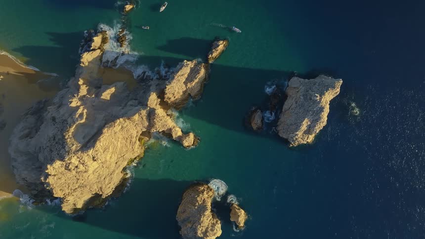 An aerial view of islands surrounded by blue sea water