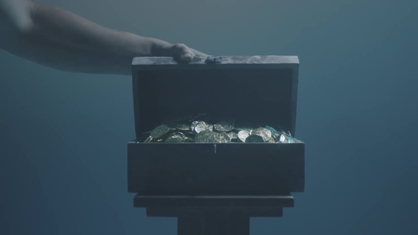 A person opens a box of coins