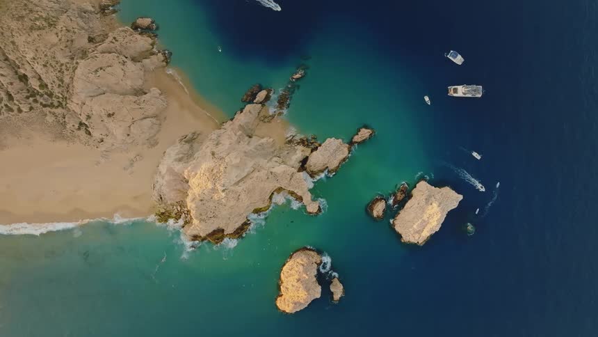 From a birdseye view a beautiful landscape unfolds below with a large body of water bordered by land on one side
