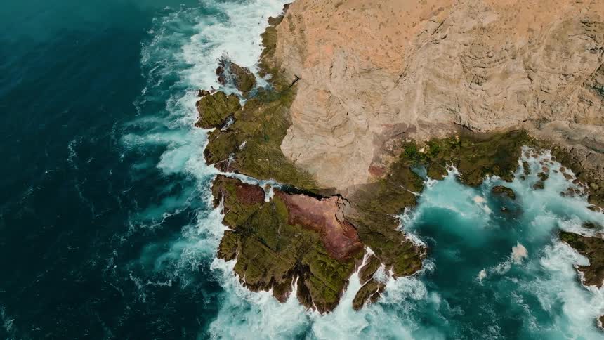 Birds eye view of an island in the ocean is displayed