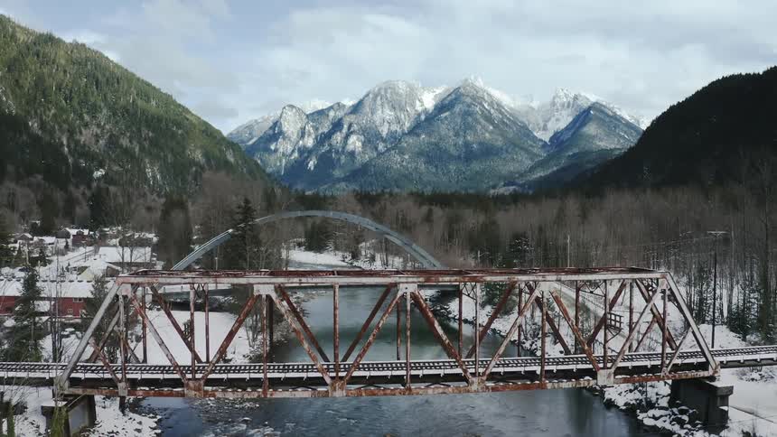 A bridge in winter above a river is displayed