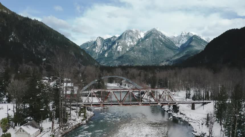 The bridge is covered in snow by the town
