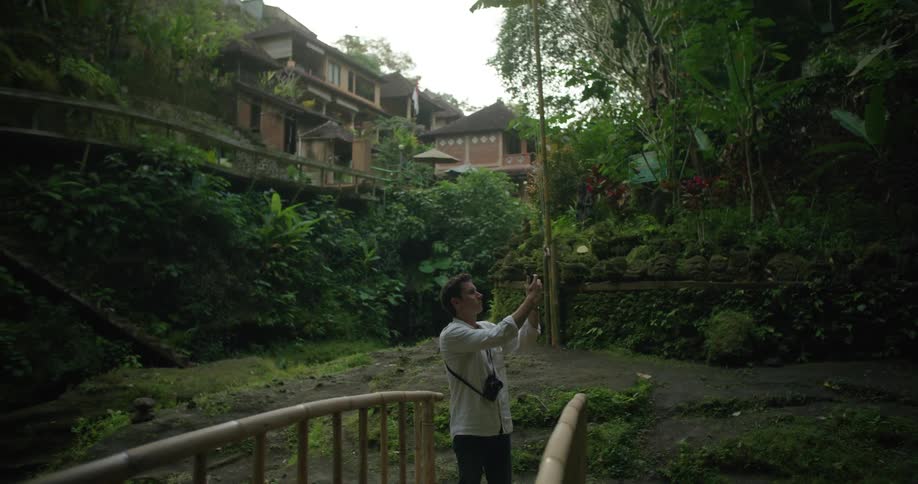 A man takes photos by the village