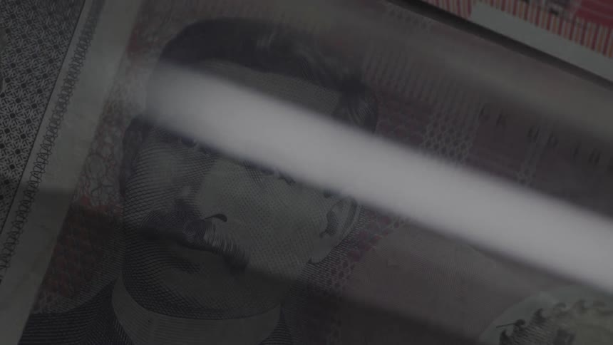 Light shines over a paper currency