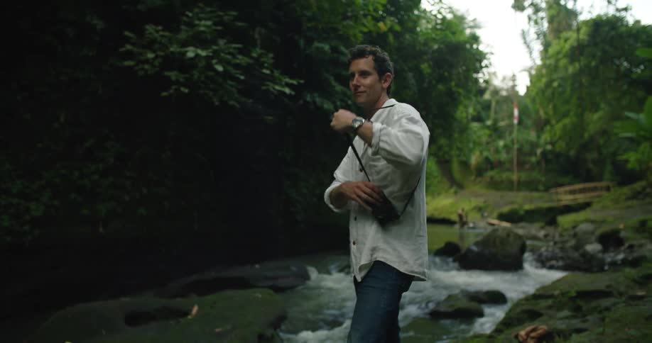 A man is outdoors hiking during the spring