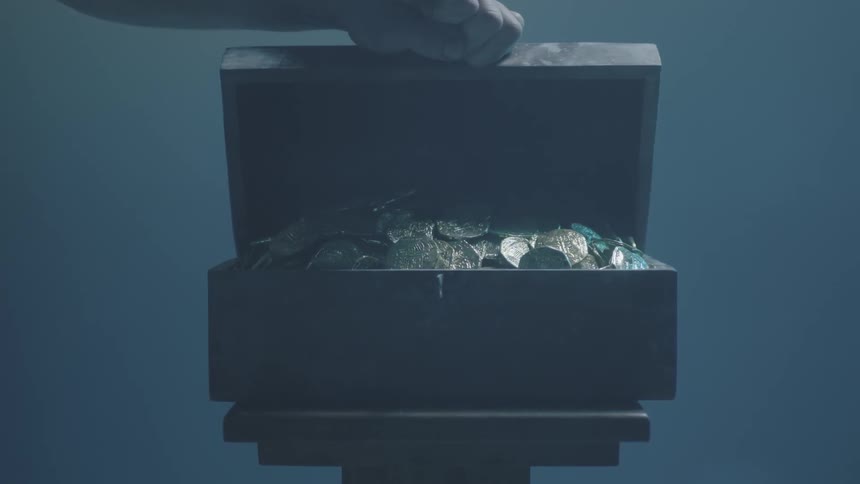 Person opening a small chest