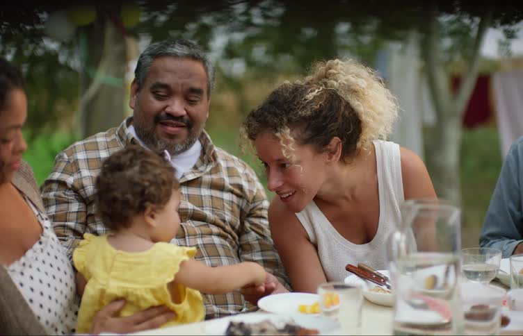 A family sitting outside at a table