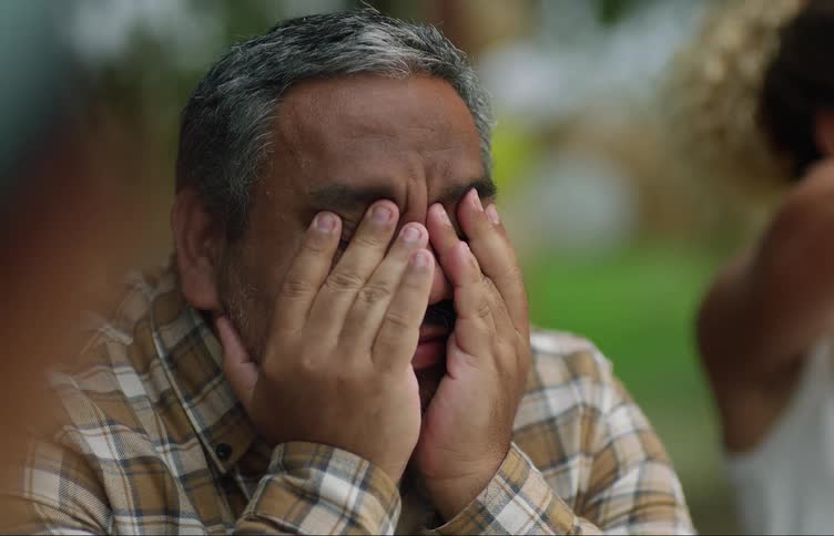 A man is covering his eyes
