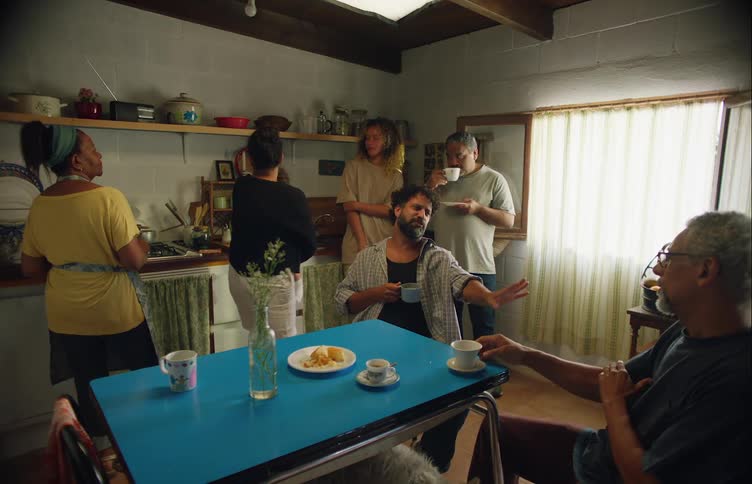 Family is hanging indoors together and eating food