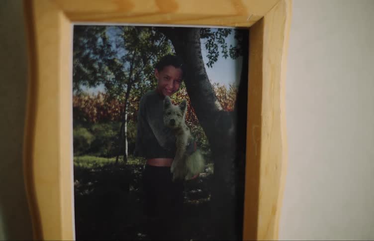 Photograph of dog and girl near cornfield sits in wooden frame
