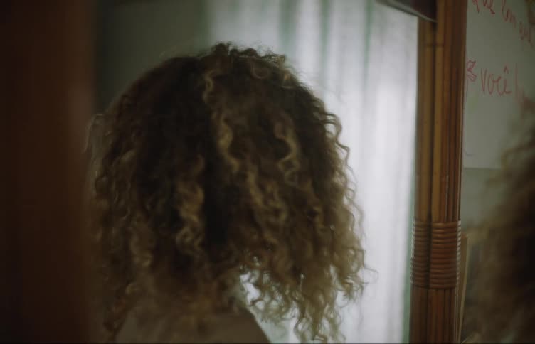 A woman walks away from the mirror