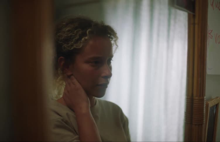 A woman ties her hair up
