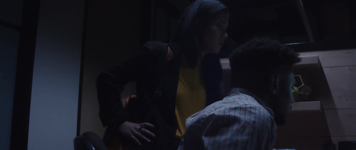 A male and female employee looking at a computer monitor in an office setting