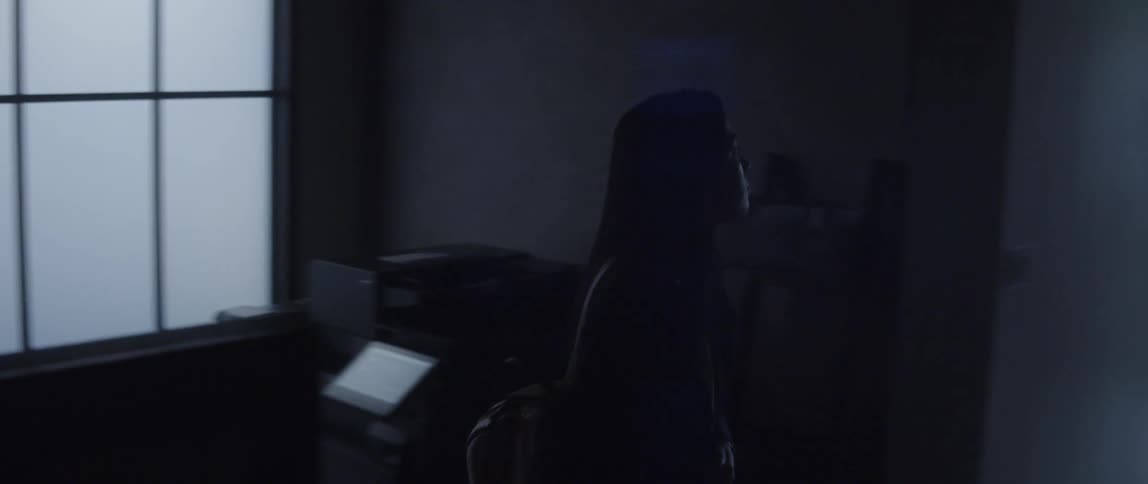 A woman says goodbye to a colleague while leaving the office