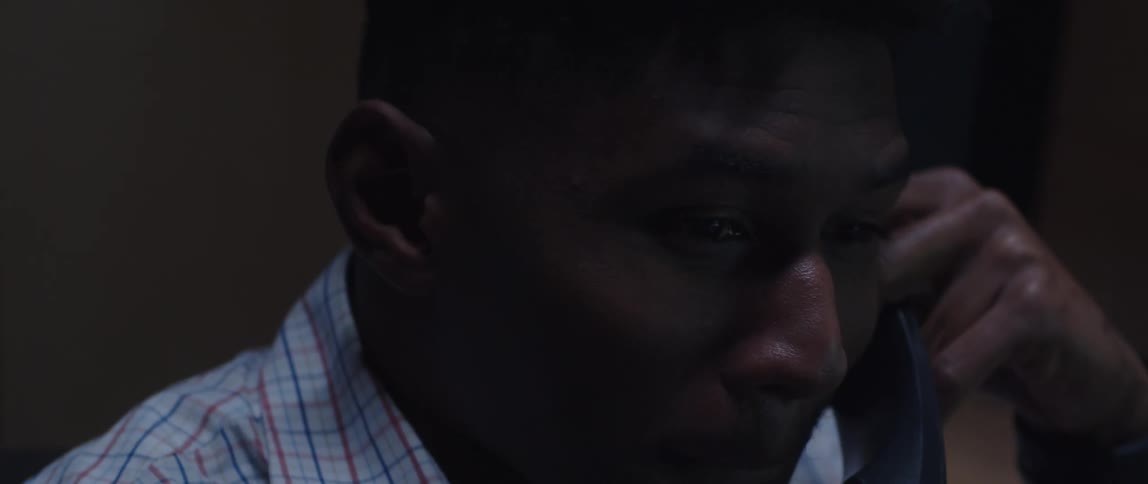 A man talking into a phone in the office
