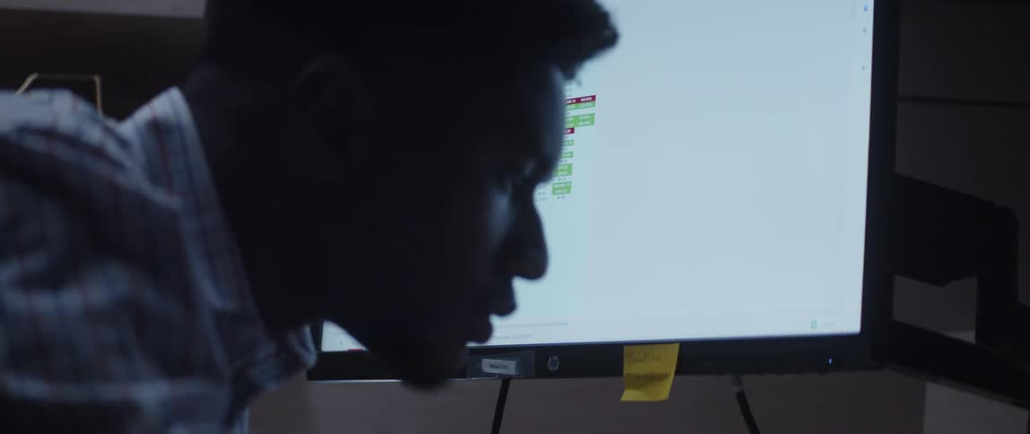 A man is looking at his computer monitor