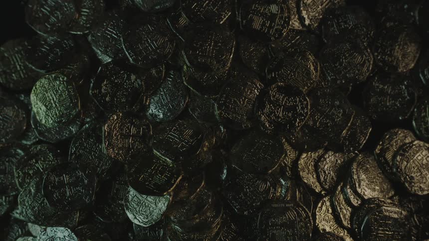 Gold coins drop onto a pile