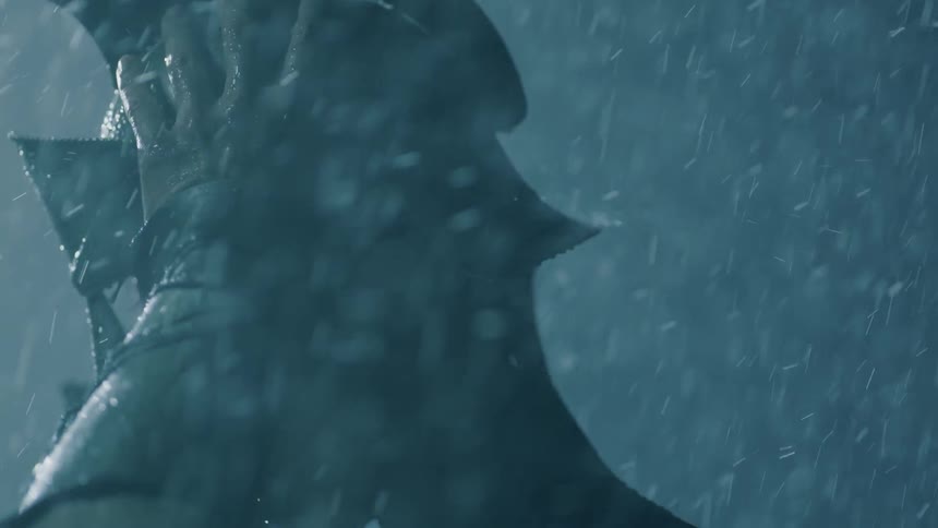 A man puts on a helmet in the rain